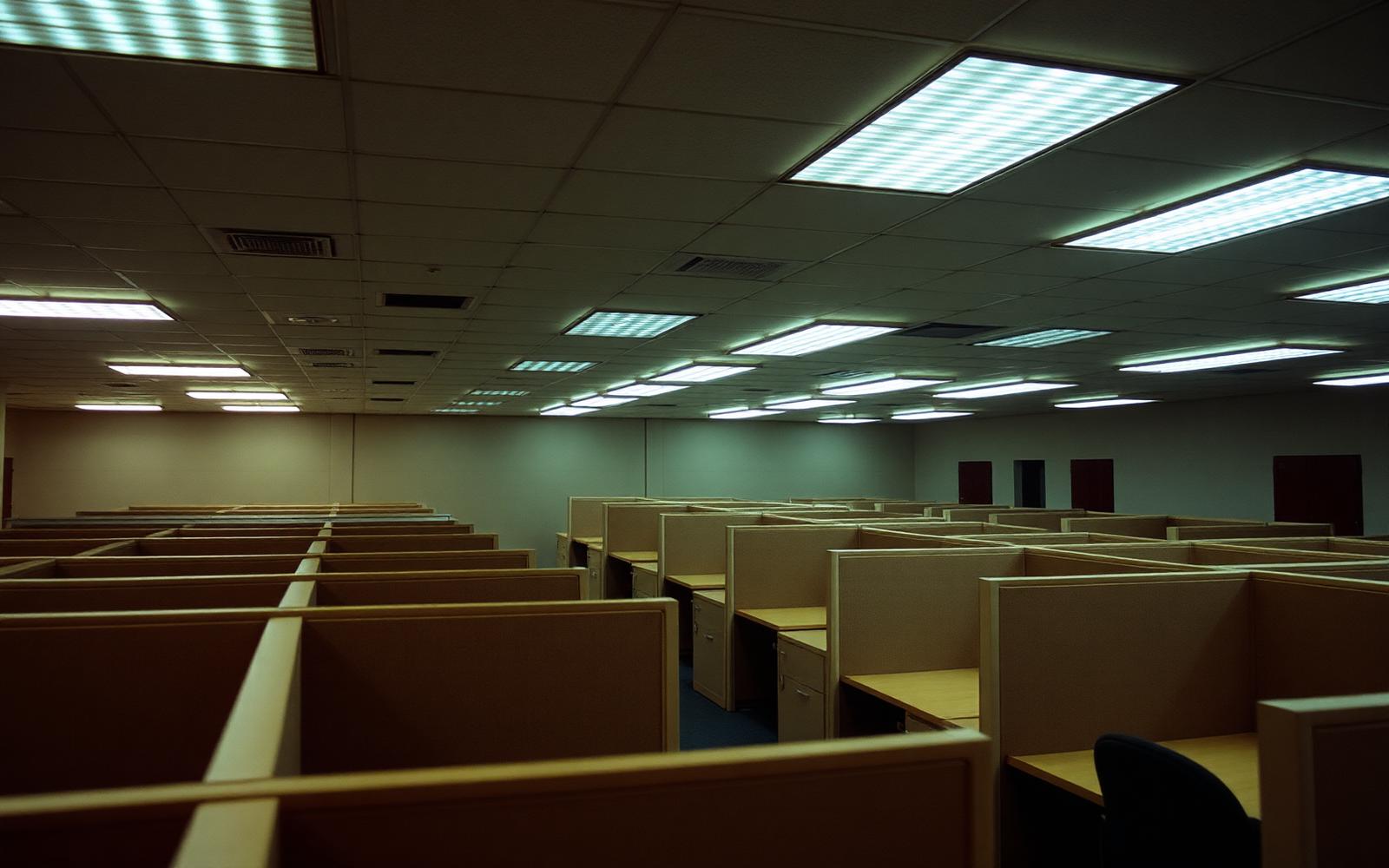 Open-plan office with monitoring equipment on desks